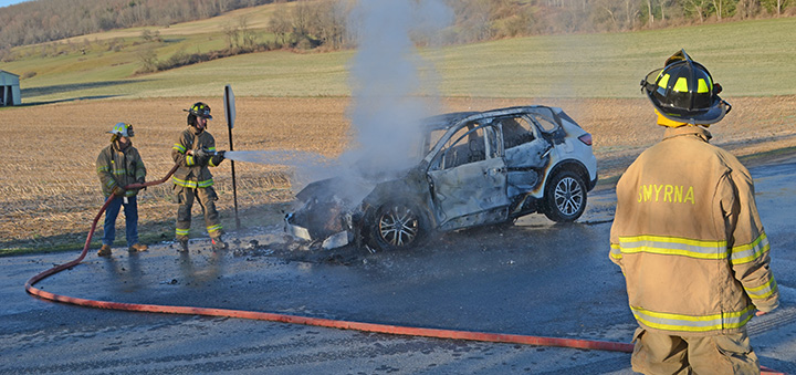 Smyrna volunteer firefighters respond to burning car in roadway